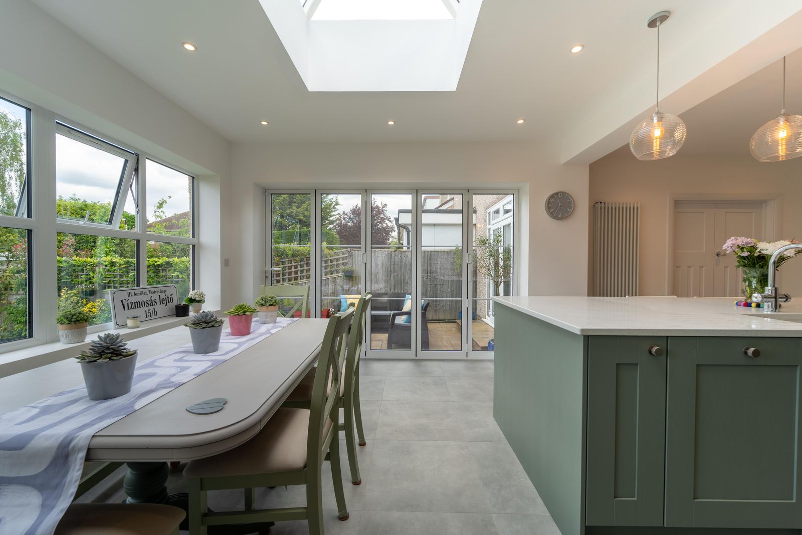 Dining area under the roof lantern with bifold doors to the garden